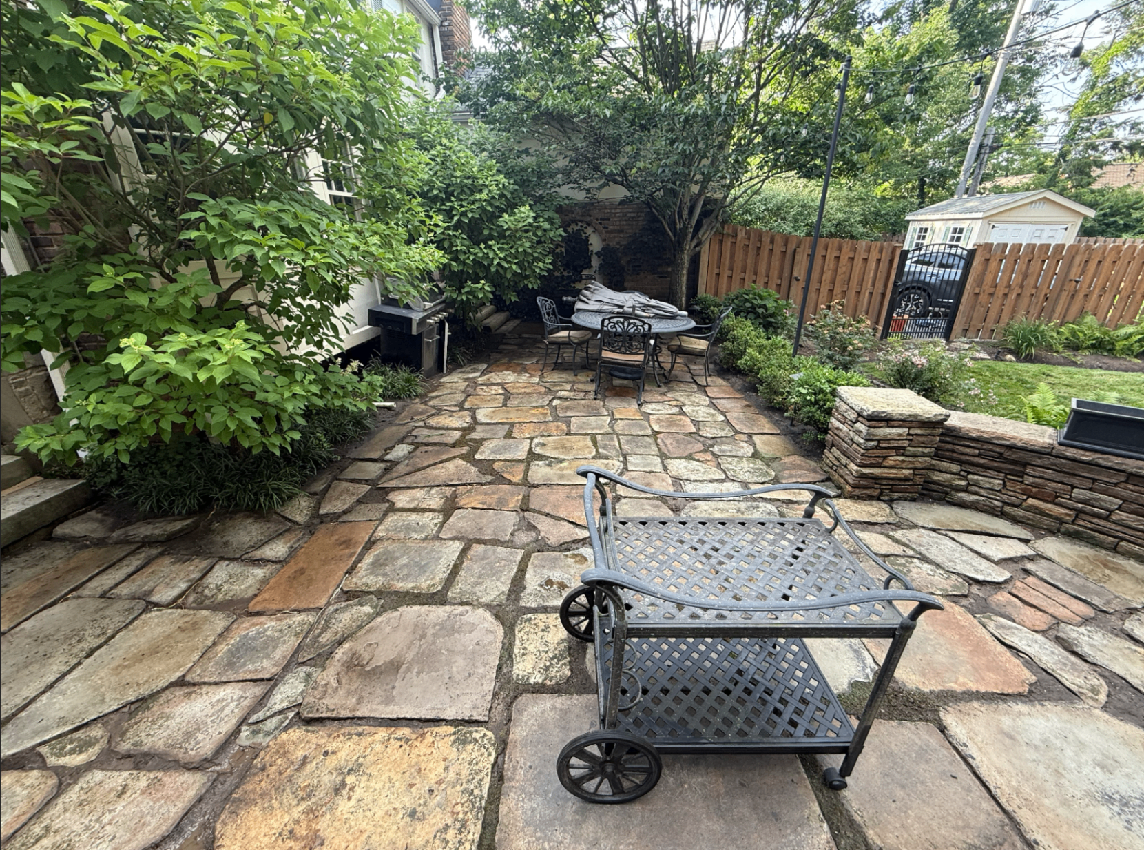 Clean stone patio with moss and grime removed after Fresh Windows pressure washing