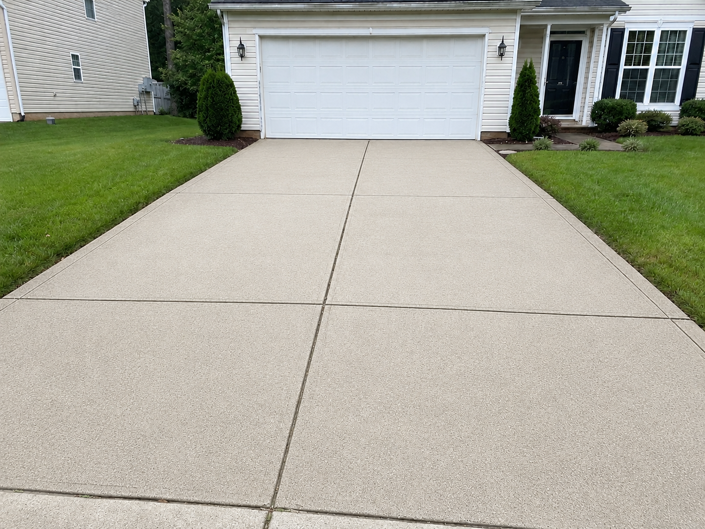 Clean, bright concrete driveway after Fresh Windows pressure washing in Northeast Ohio